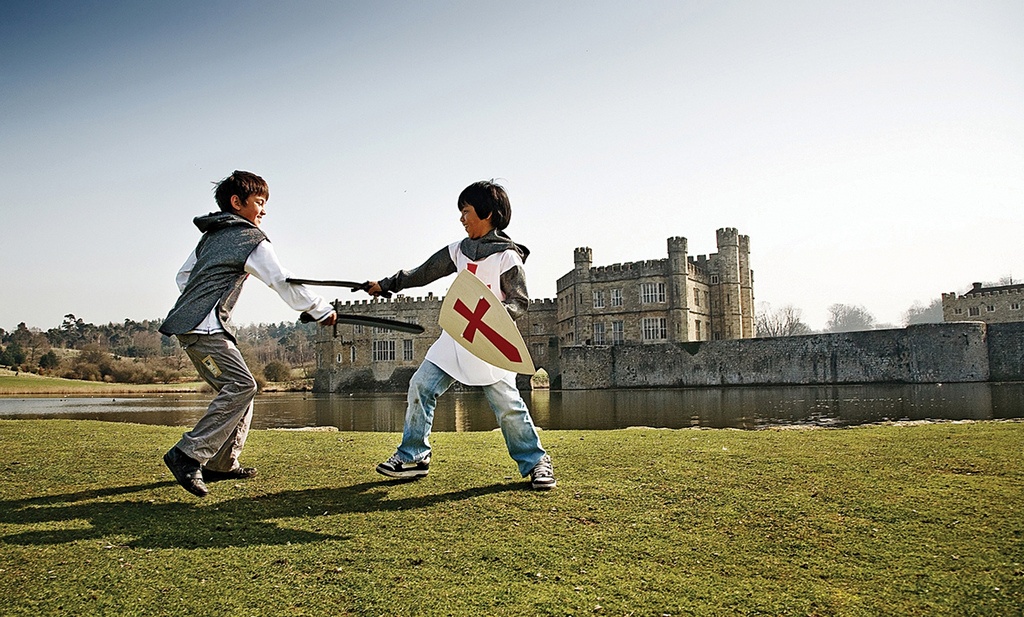 Two children dressed as knights, playing outside Leeds Castle