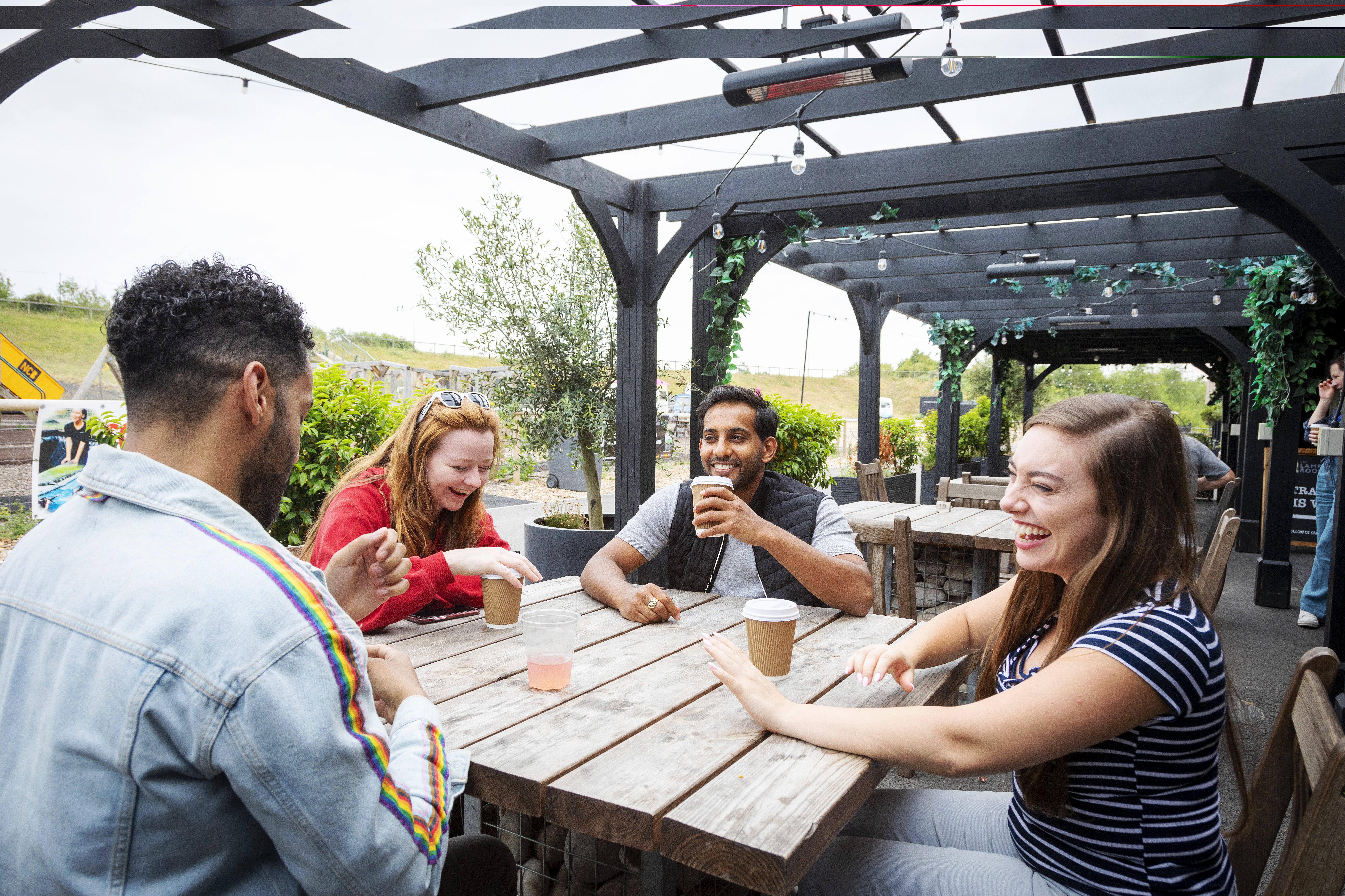 Group enjoying a drink outside at The Lamp Room