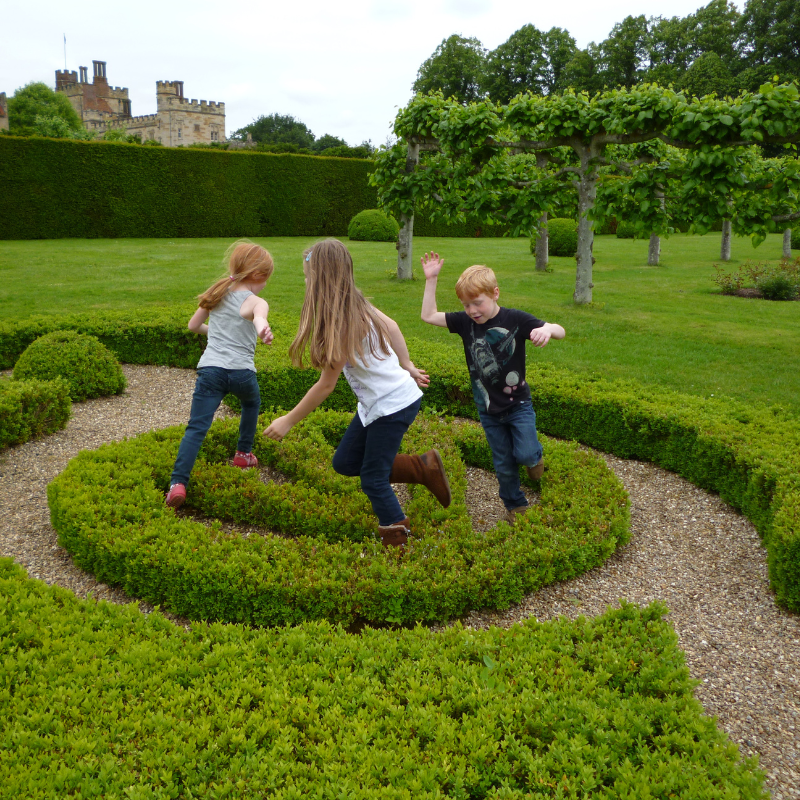 Children running through the gardens at Penshurst Place