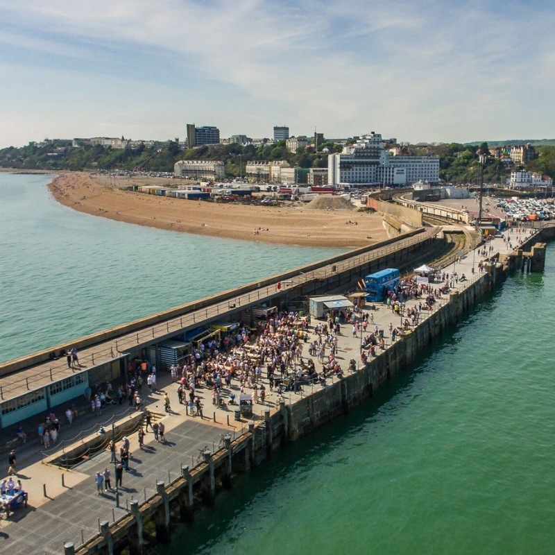 Aerial view of Folkestone Harbour Arm and Mermaid Beach beyond