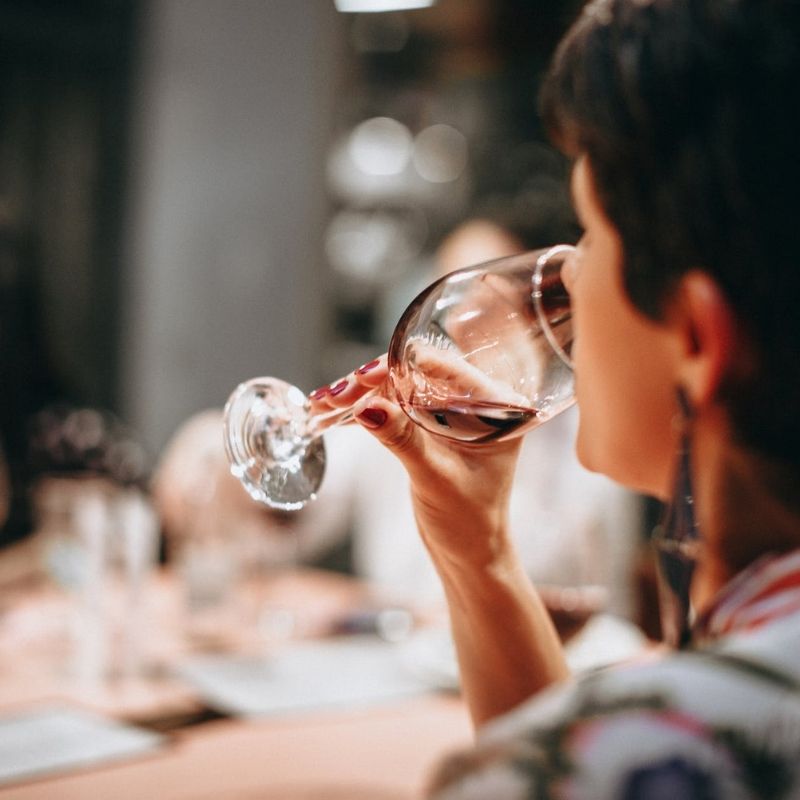 Woman drinking class of red wine