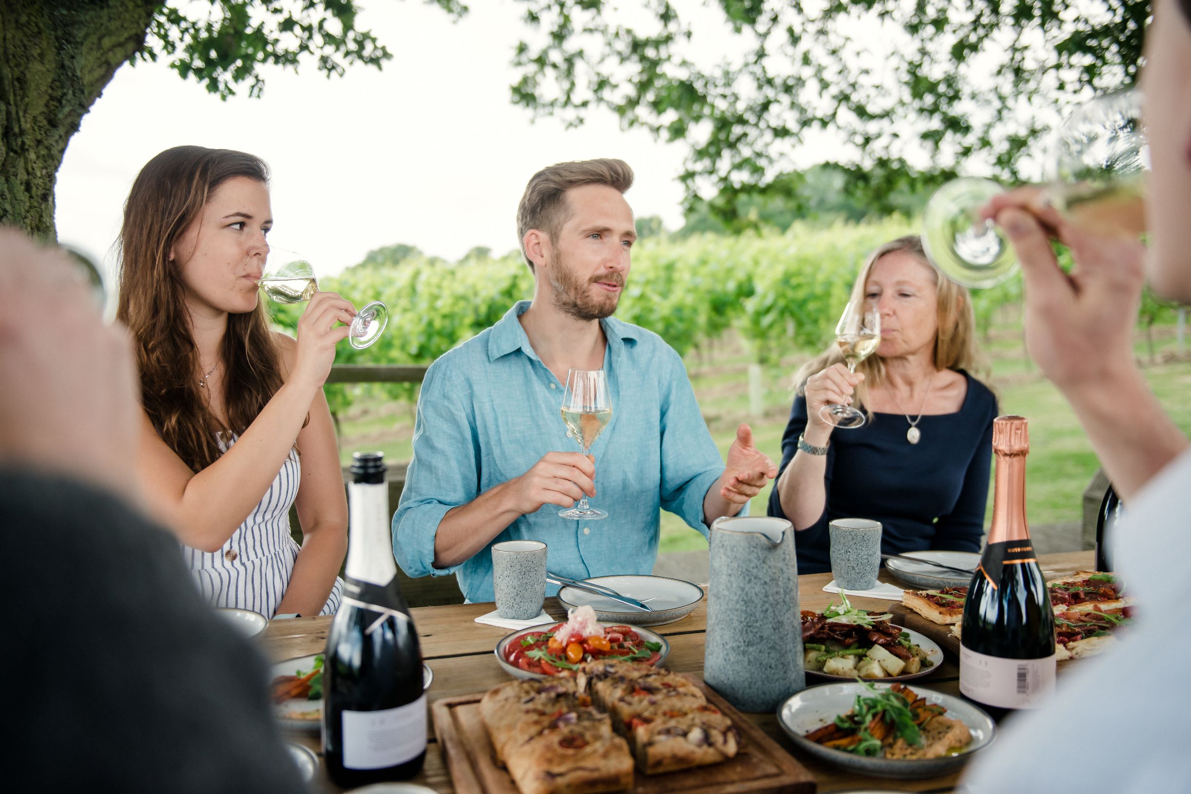 Group enjoying lunch outside at Gusbourne vineyard