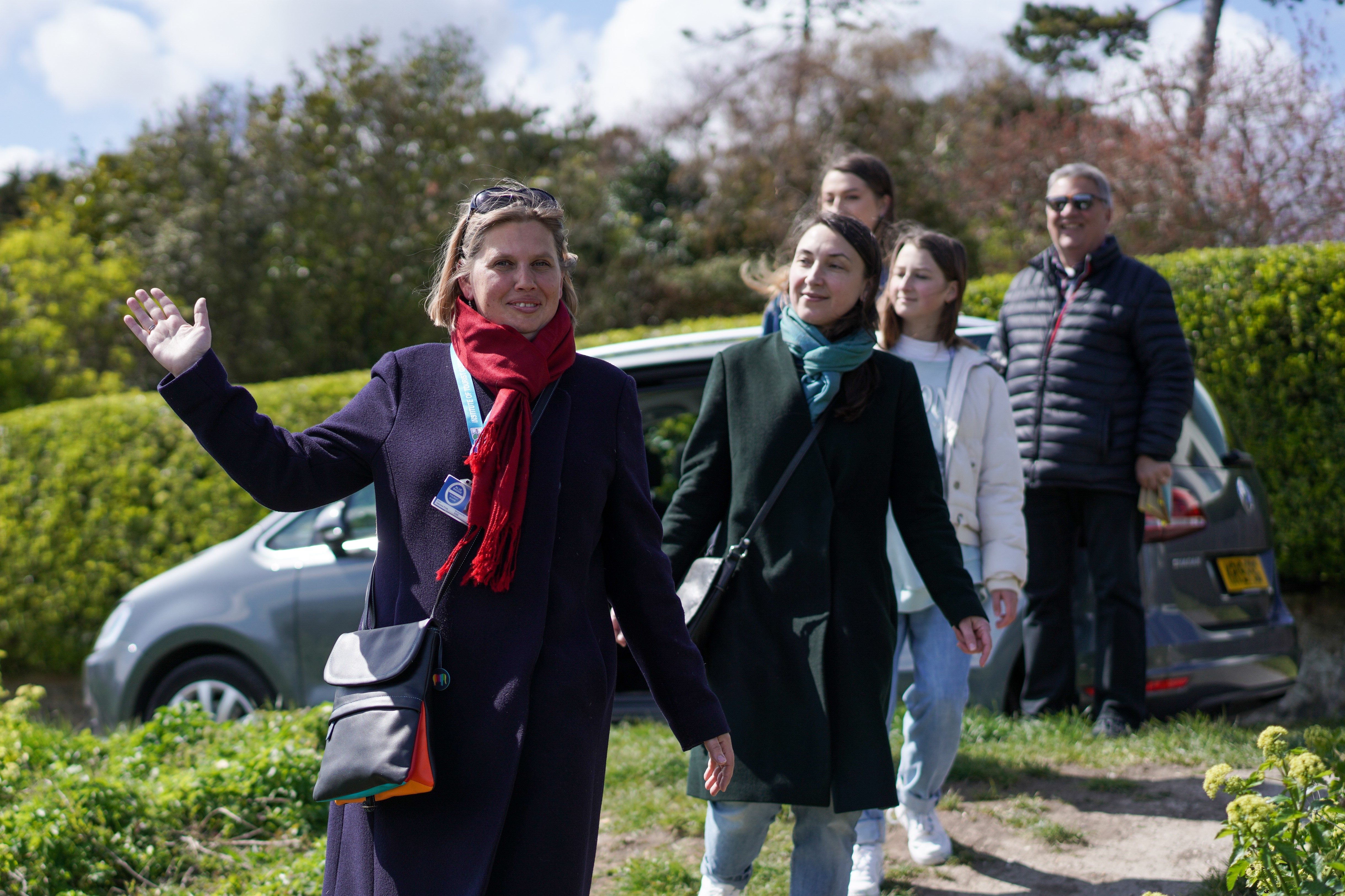 Tour guide leading family
