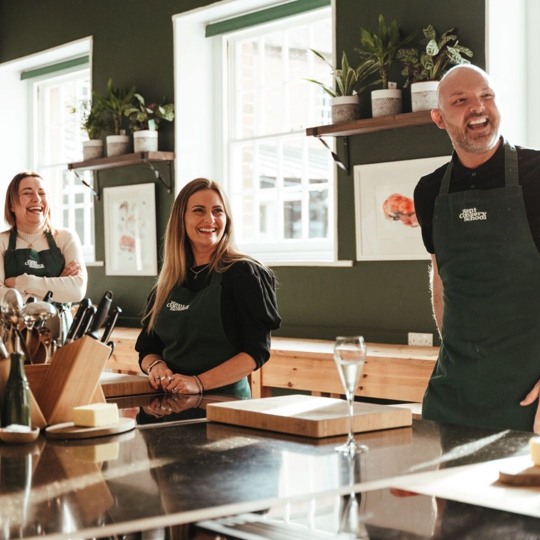 Three people at a Kent Cookery School workshop