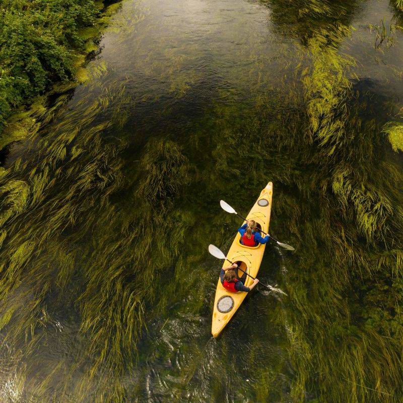 Aerial view of kayakers paddling along River Stour in double kayak